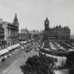General view of Princes Street from Scott Monument to the east showing the North British Hotel, Waverley Gardens, Calton Hill and a busy street with pedestrians, trams and cars
