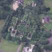 Oblique aerial view centred on the remains of the country house, taken from the E.