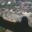 Oblique aerial view of Clydebank centred on John Brown's Shipyard and crane, taken from the SW.