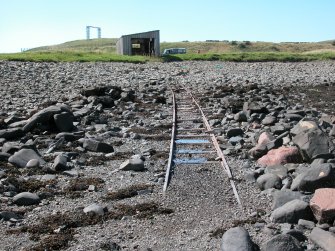 View looking W along slipway with boat house in background
