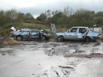 View of wrecked cars in bomb testing area