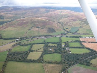 Oblique aerial view looking over the Country House, policies, stable and dovecot towards Startup Hill and beyond, taken from the NNE.