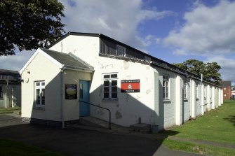 View.  Domestic site, pre-1933 barrack block hut, now Police Club from SSE.
