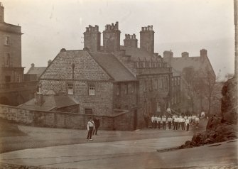 Digital image of historic photograph.
View from SE with soldiers outside.
Mount signed: 'Thomas Ross' and inscribed: 'Edinburgh Castle. December. 1912.'