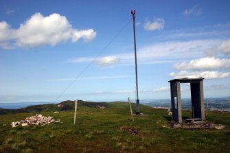 View of marker cairn, beacon and sentry box on summit of Castlelaw Hill, taken from SW