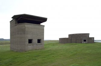 View.  Coast Battery Battery Observation Post (BOP) showing ground floor windows and first floor viewing platform with canopy and in background the rear of gun-emplacement from S.