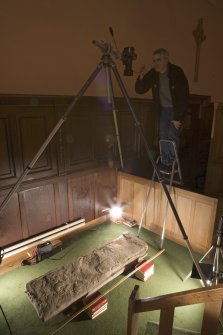Interior. Mr S Wallace photographing pictish cross slab