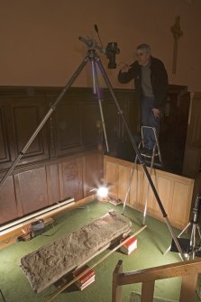 Interior. Mr S Wallace photographing pictish cross slab