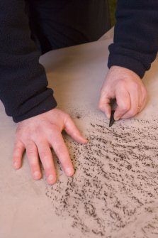 Interior. Mr J Borland making a rubbing of a pictish cross slab