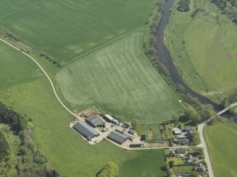 Oblique aerial view centred on the remains of the recumbent stone circle with the farmhouse and farmsteading adjacent, taken from the NW.