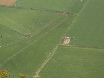 Oblique aerial view centred on the remains of the recumbent stone circle, taken from the NW.