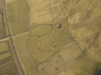 Oblique aerial view centred on the remains of the settlement, taken from the SSW.