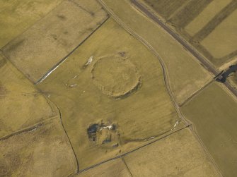 Oblique aerial view centred on the remains of the settlement, taken from the NE.