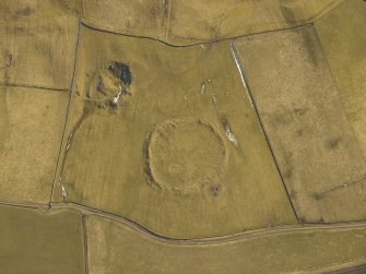 Oblique aerial view centred on the remains of the settlement, taken from the W.