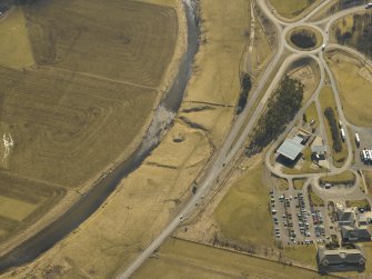 Oblique aerial view centred on the remains of the motte and bailey, taken from the NNW.