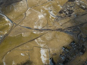 Oblique aerial view of the village, the railway and the remains of the field banks, taken from the NNW.