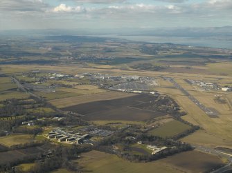 General oblique aerial view of the offices with the airport beyond, taken from the S.