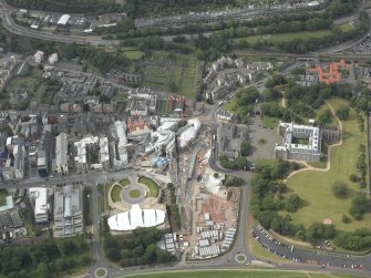 Oblique aerial view centred on the construction of the Scottish Parliament with the exhibition centre and palace adjacent, taken from the SE.