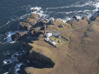 Oblique aerial view centred on the lighthouse and buildings, taken from the WSW.