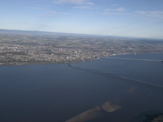 General oblique aerial view looking across the Firth of Tay, the road and rail bridges towards the city of Dundee, taken from the SW.