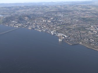General oblique aerial view looking across the Firth of Tay and the road bridge towards the city of Dundee, taken from the SE.