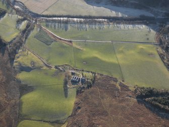 General oblique aerial view of Colmeallie centred on the remains of the stone circle, taken from the NW.