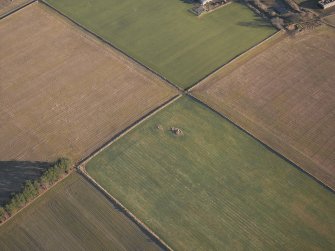 Oblique aerial view centred on the remains of the recumbent stone circle, taken from the W.

