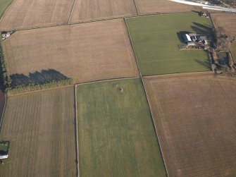 Oblique aerial view centred on the remains of the recumbent stone circle with the farmsteading adjacent, taken from the SW.