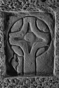 View of medieval grave slab built into W gable of church (B&W)