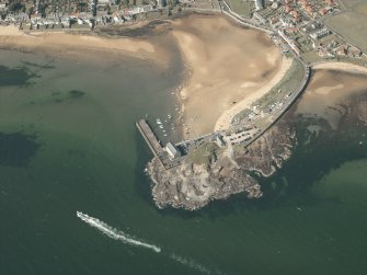 Oblique aerial view centred on the pier, granary and harbour, taken from the SW.