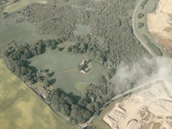 General oblique aerial view of the remains of the priory and the house, taken from the SW.