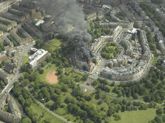 General oblique aerial view of Park Circus and the housing during the fire in Park Gate, taken from the NW.
