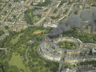 General oblique aerial view of Park Circus and the housing during the fire in Park Gate, taken from the SSW.
