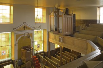 Interior. View from NE at gallery level showing pulpit and organ