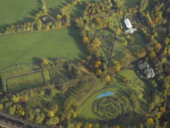 Oblique aerial view of the gardens, museum and conservatory, taken from the SSW.