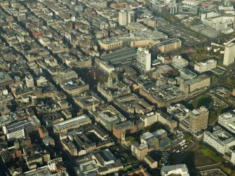 General oblique aerial view of the square, shopping centre, station and city chambers, taken from the SE.