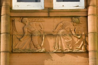 Detail of carved panel on north east facade (fishing and netmaking).