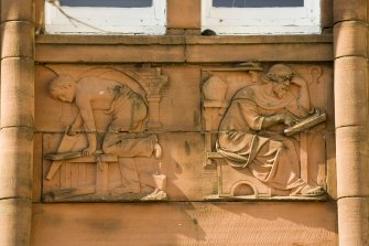 Detail of carved panel on north east facade (joinery and St. Columba)