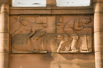 Detail of carved panel on north east facade (distilling and mining).