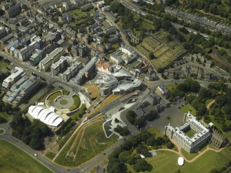 Oblique aerial view centred on the Scottish Parliament with the exhibition centre and palace adjacent, taken from the SE.