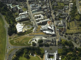 Oblique aerial view centred on the Scottish Parliament with the exhibition centre adjacent, taken from the ENE.