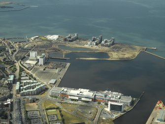 Oblique aerial view of the docks, mills and shopping centre, taken from the SE.