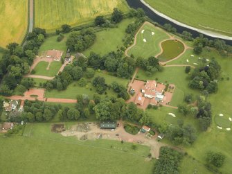 Oblique aerial view centred on the house, taken from the NW.