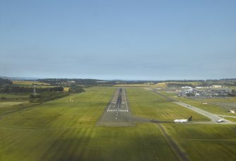 Oblique aerial view of the runway at the airport while coming in to land, taken from the SW.