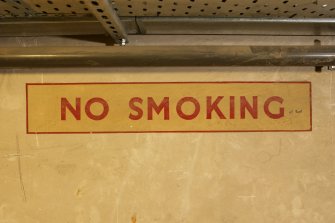 Interior. Basement, corridor, detail of WW II 'No smoking' sign