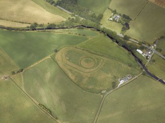 Oblique aerial view centred on the remains of the motte and bailey castle, taken from the SW.