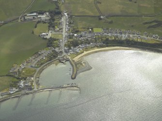 Oblique aerial view centred on the village and harbour, taken from the NE.
