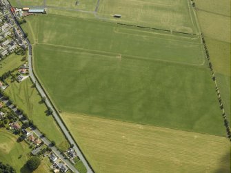 Oblique aerial view centred on the parchmarks of the cursus, taken from the WNW.