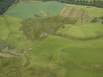 Oblique aerial view centred on the remains of the farmstead and the SW rampart of the Roman Fort, taken from the ESE.