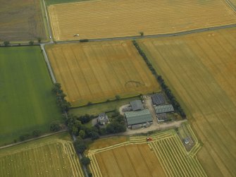 Oblique aerial view centred on the farmhouse, farmstead and stables, taken from the NNW.

